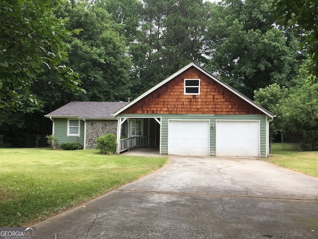 view of front of house with a front yard and a garage