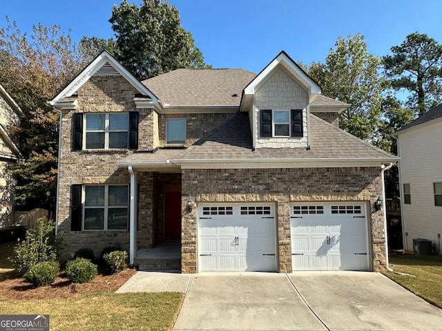 craftsman house featuring a front yard and a garage