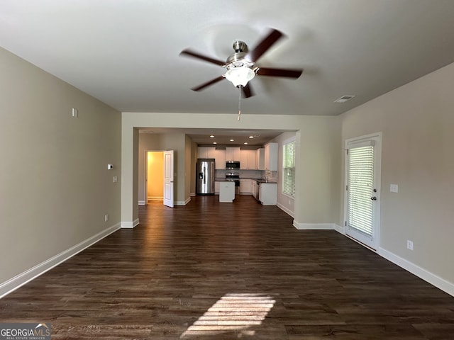 unfurnished living room with dark wood-type flooring and ceiling fan