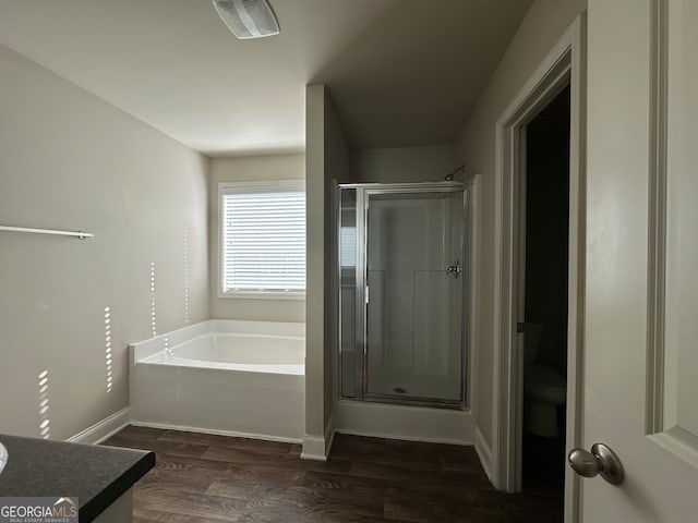 full bathroom featuring vanity, hardwood / wood-style flooring, toilet, and separate shower and tub