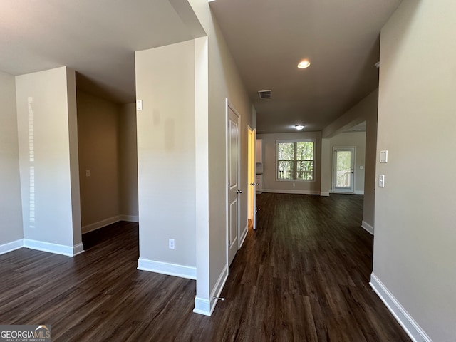 hallway with dark wood-type flooring