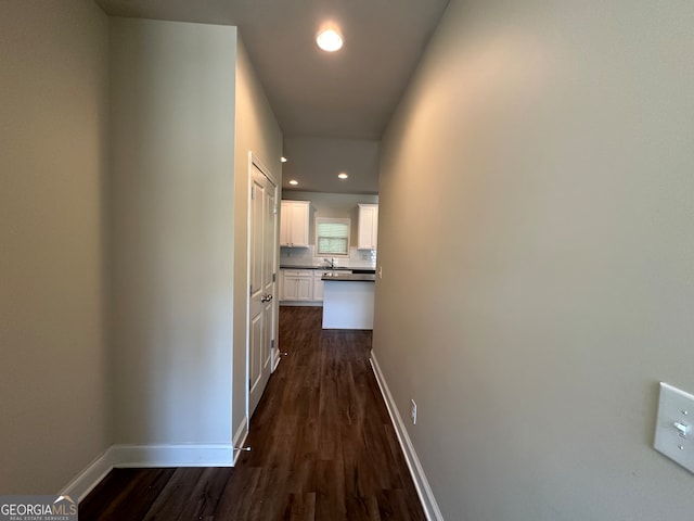 hallway featuring dark hardwood / wood-style flooring