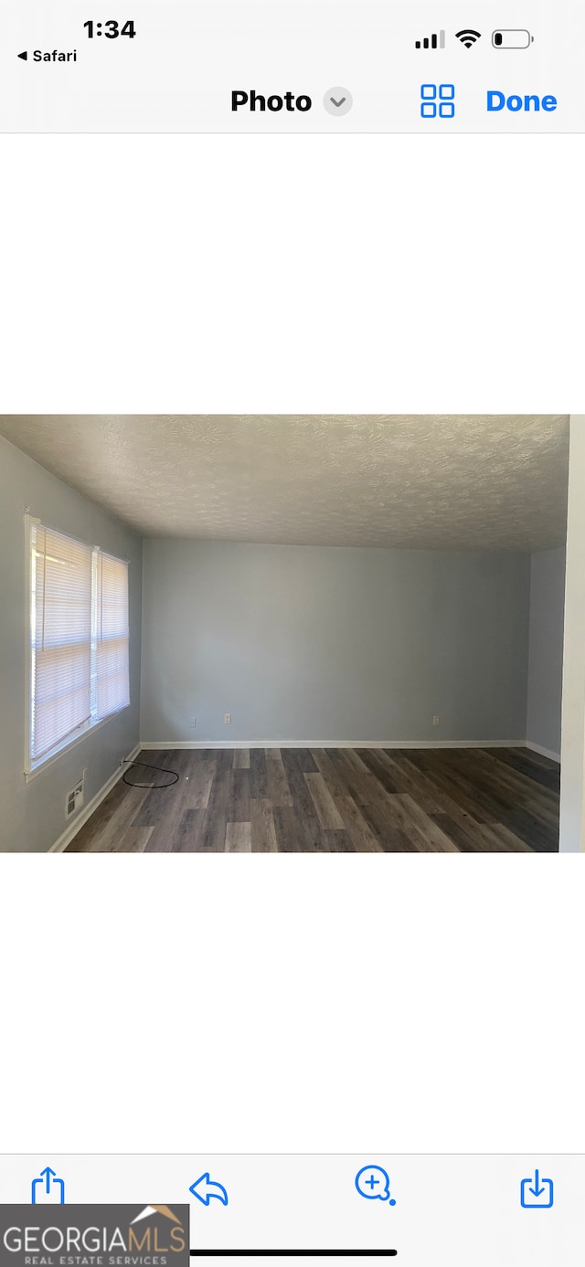 spare room with dark hardwood / wood-style floors