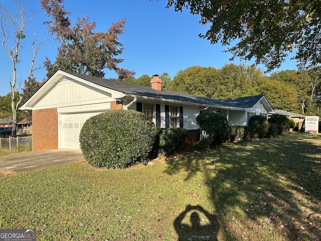 view of front of home with a front lawn and a garage