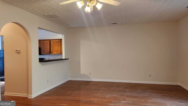 unfurnished room with a textured ceiling, hardwood / wood-style flooring, and ceiling fan