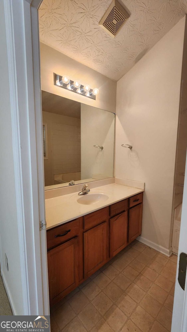 bathroom with vanity and tile patterned flooring