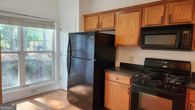 kitchen with black appliances and light wood-type flooring