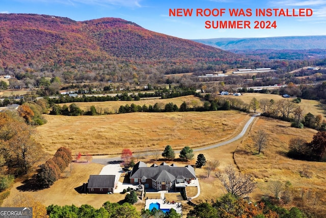 birds eye view of property with a mountain view and a rural view