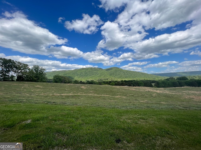 mountain view featuring a rural view