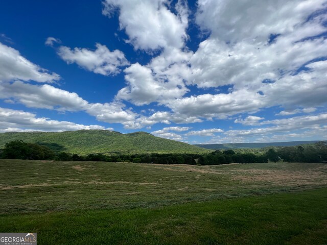 mountain view featuring a rural view