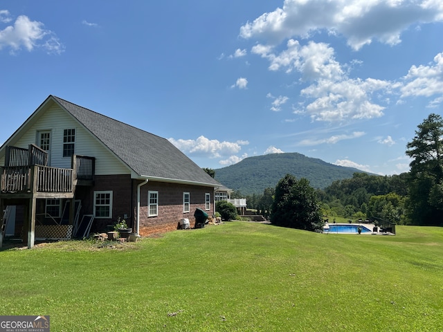 exterior space with a pool side deck with mountain view