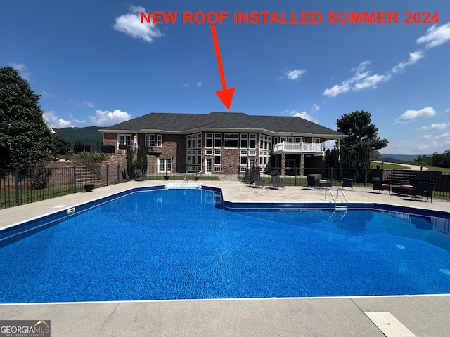 view of swimming pool with a patio area