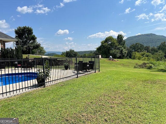 view of yard with a fenced in pool and a mountain view