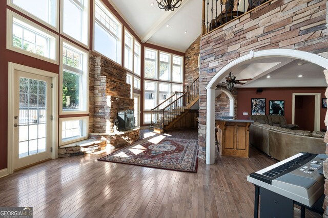 interior space with a healthy amount of sunlight, hardwood / wood-style floors, and high vaulted ceiling