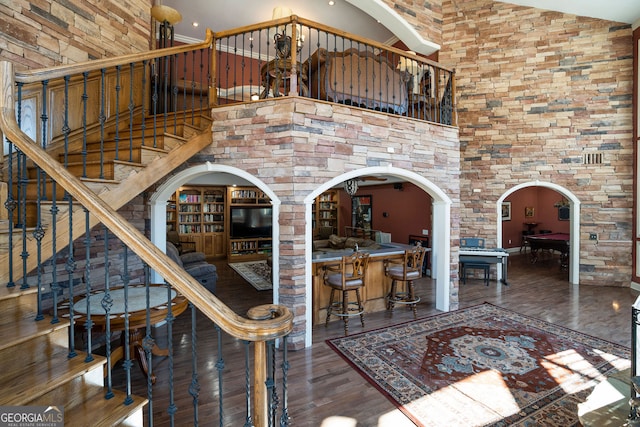 dining space with high vaulted ceiling and dark hardwood / wood-style floors