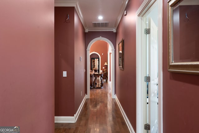 hallway with ornamental molding and dark wood-type flooring