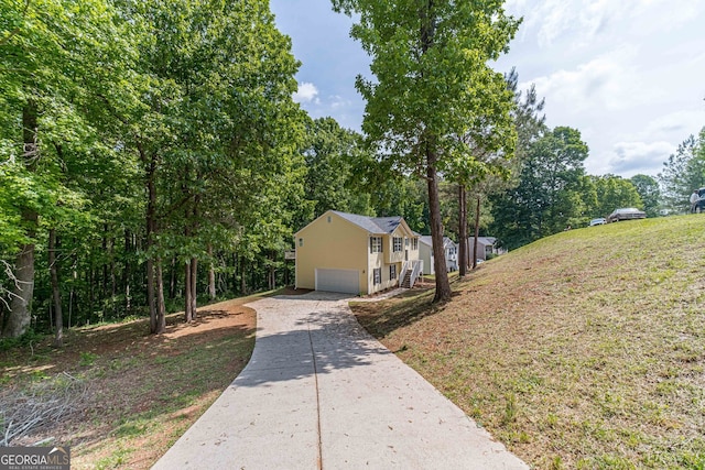 view of side of home with a yard and a garage