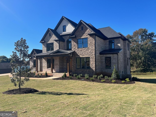 view of front of home featuring board and batten siding, a front yard, a standing seam roof, and covered porch