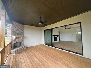 exterior space with a brick fireplace and a ceiling fan