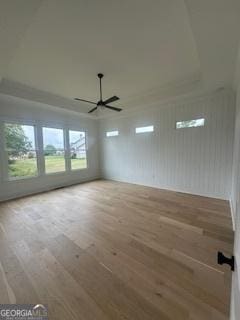 unfurnished room with wood finished floors and a ceiling fan