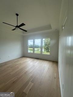 empty room with wood finished floors and a ceiling fan