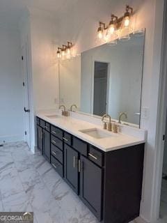 bathroom with marble finish floor, a sink, and double vanity