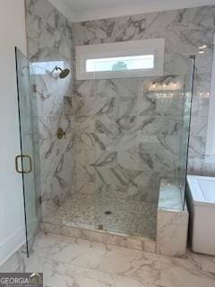 bathroom featuring marble finish floor, a freestanding tub, and a marble finish shower