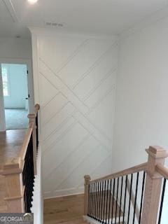 stairs featuring wood finished floors