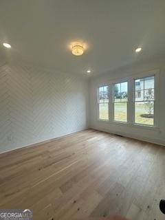 unfurnished room with wood finished floors and recessed lighting