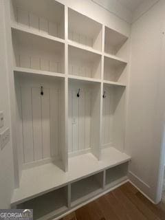 mudroom with dark wood-type flooring and baseboards