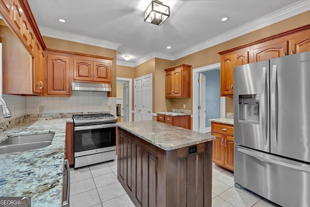 kitchen with light tile patterned flooring, appliances with stainless steel finishes, sink, and tasteful backsplash