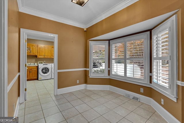 interior space featuring ornamental molding, light tile patterned floors, and washer / clothes dryer