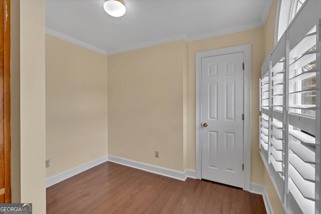 unfurnished room featuring crown molding and wood-type flooring