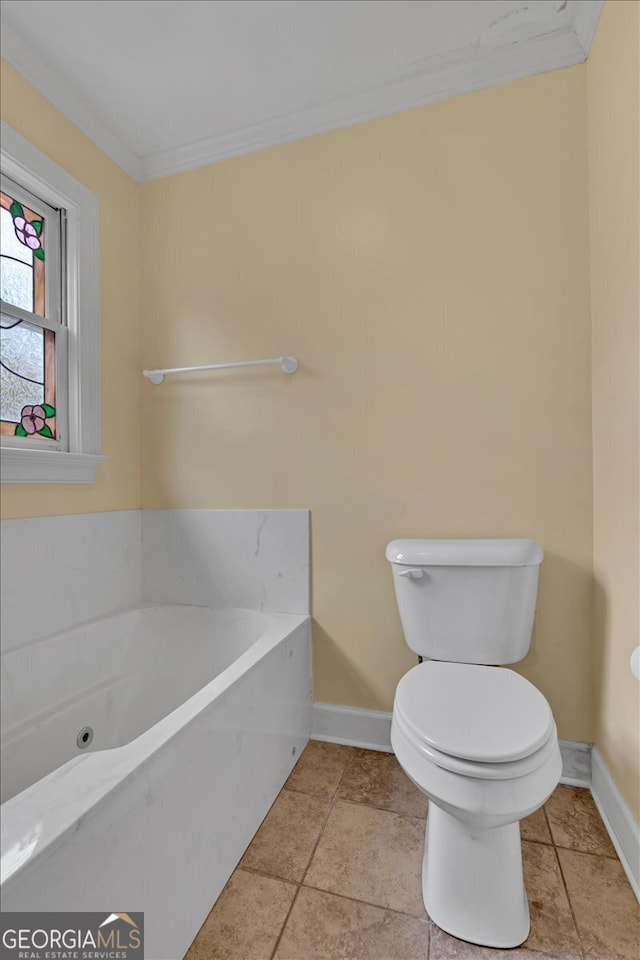 bathroom with crown molding, toilet, and a washtub