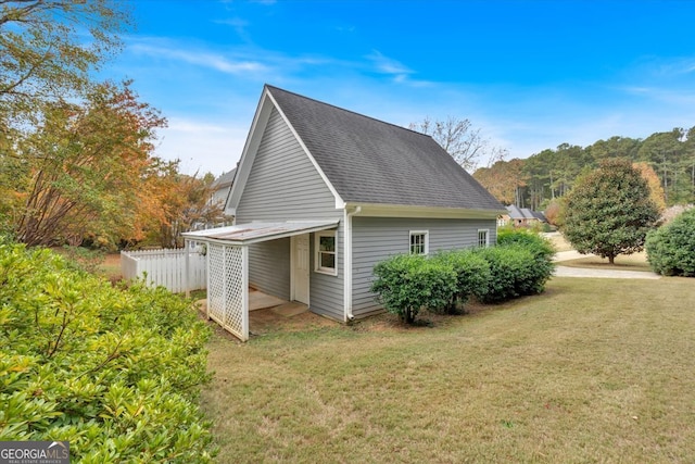 view of side of home with a lawn