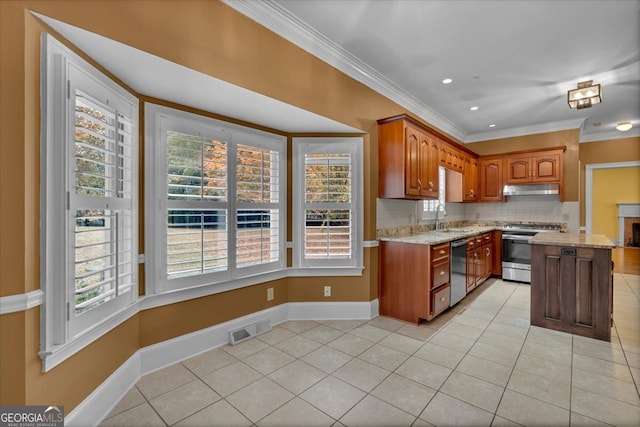 kitchen with sink, stainless steel appliances, and a wealth of natural light