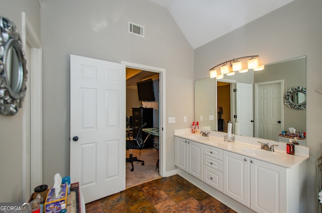 bathroom featuring vanity and lofted ceiling