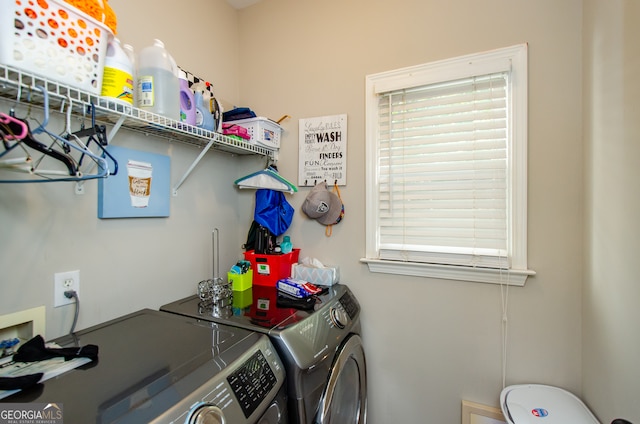 clothes washing area featuring washing machine and clothes dryer