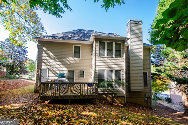 back of property featuring a wooden deck