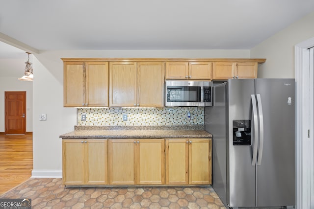 kitchen featuring light brown cabinetry, decorative backsplash, and appliances with stainless steel finishes