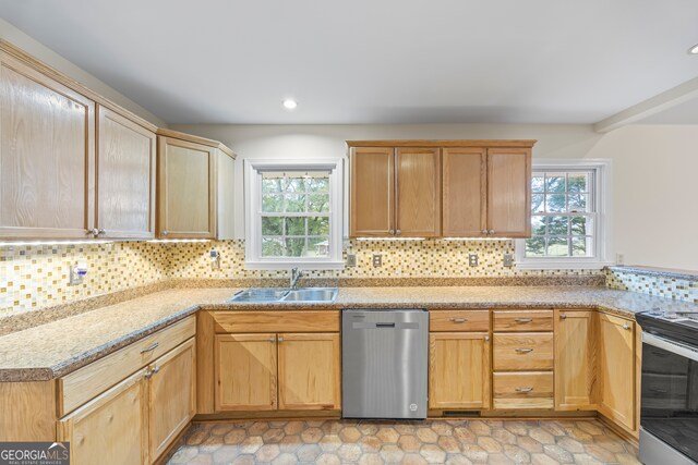 kitchen with appliances with stainless steel finishes, tasteful backsplash, sink, and a wealth of natural light