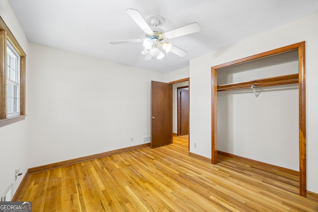 unfurnished bedroom featuring a closet, light wood-type flooring, and ceiling fan