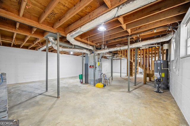 basement featuring gas water heater and heating unit