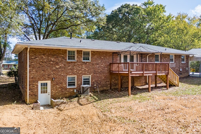 rear view of property featuring cooling unit and a deck