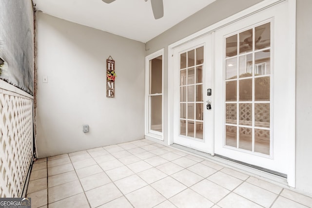 unfurnished sunroom featuring ceiling fan