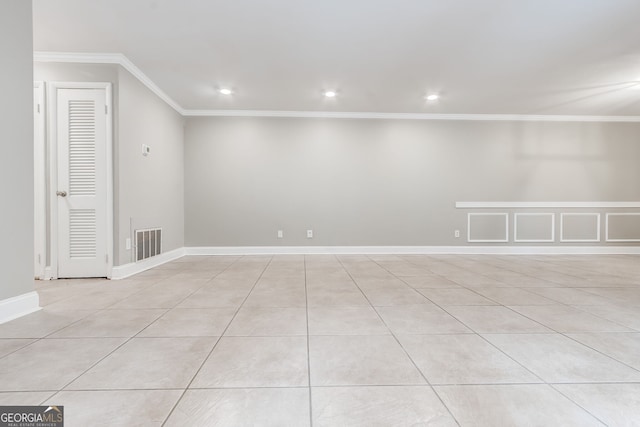 tiled spare room with ornamental molding