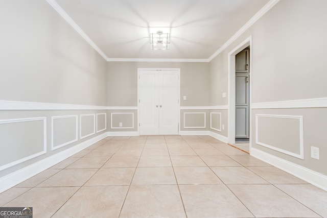 tiled empty room featuring ornamental molding