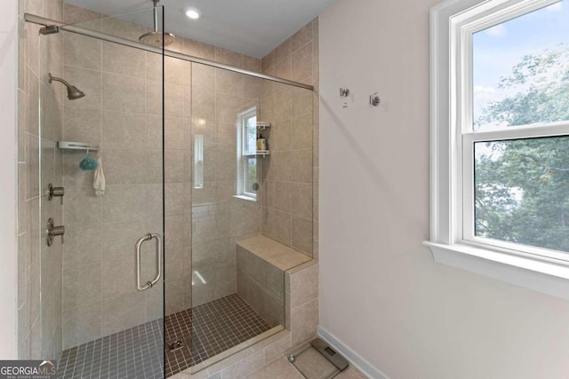 bathroom featuring a shower with shower door