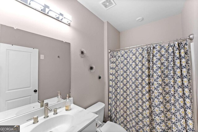 bathroom with vanity and toilet