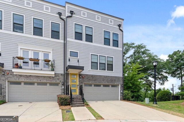 multi unit property with a garage and a balcony